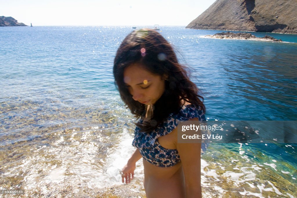 Young woman paddling in sea, Marseille, France