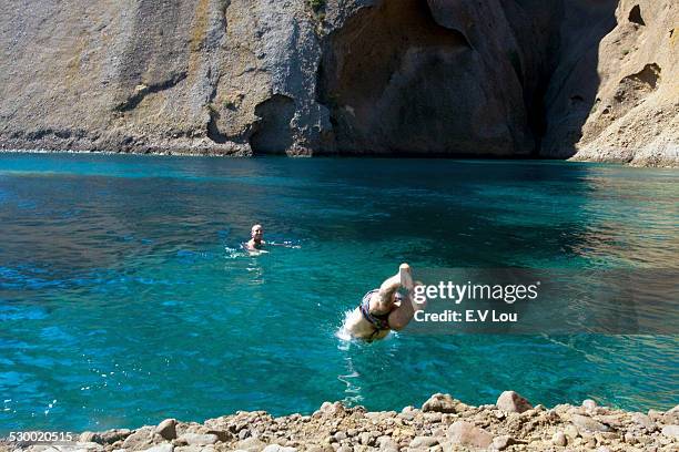 two young men diving into sea and swimming, marseille, france - 馬賽族 個照片及圖片檔