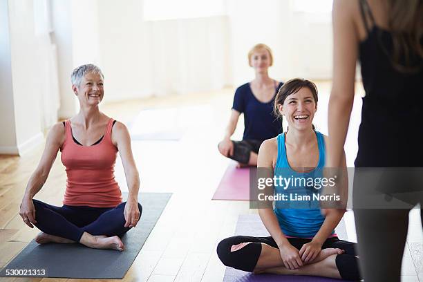 female students watching and listening to tutor in pilates class - group gym class bildbanksfoton och bilder