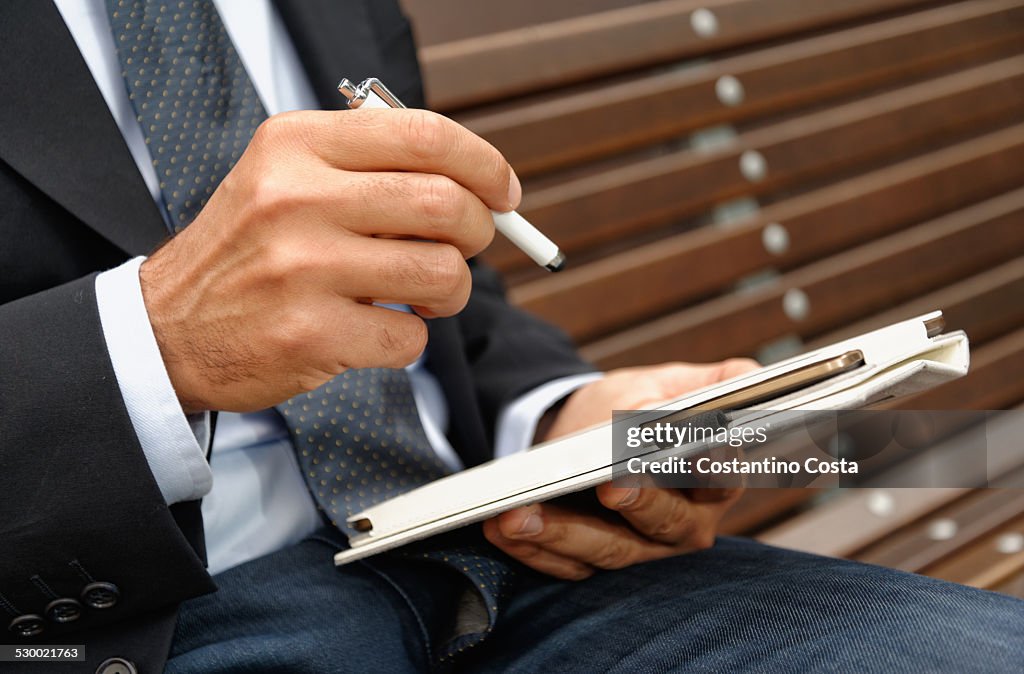 Man using digital tablet and stylus, focus on hands