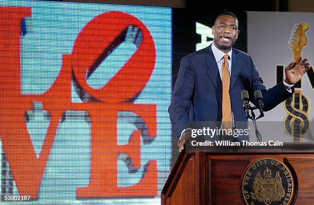 Dikembe Mutumbo speaks with reporters during a news conference to announce the upcoming Live Eight concert to raise money to aid Africa May 31, 2005...