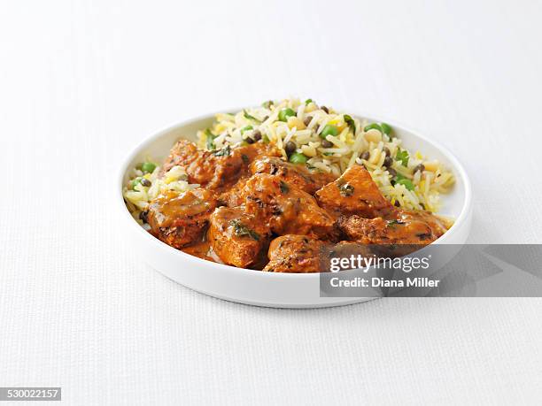 bowl of chicken tikka masala and peas with steamed rice - homemade meal stock pictures, royalty-free photos & images