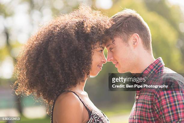 young couple face to face in park - bethnal green fotografías e imágenes de stock