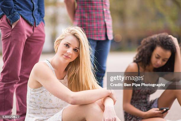 portrait of young woman with friends in park - bethnal green fotografías e imágenes de stock