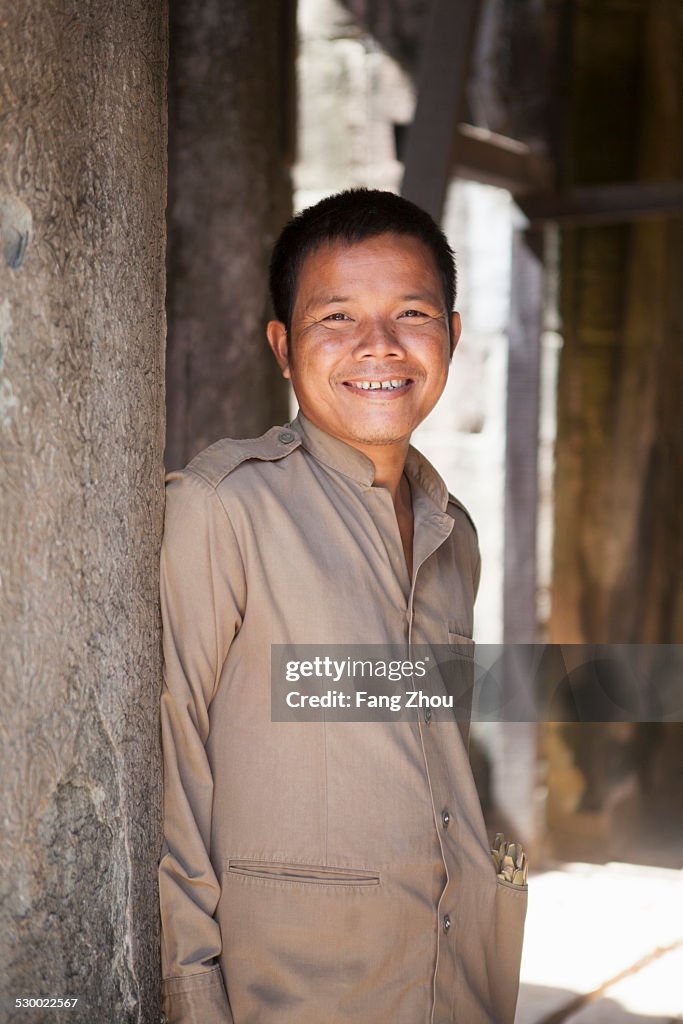 Cambodia man standing by temple, Siem Reap, Cambodia