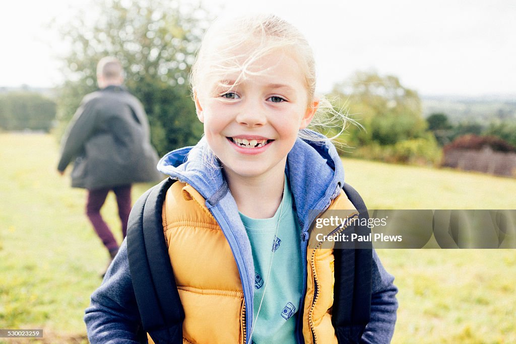 Young girl wearing bodywarmer, smiling