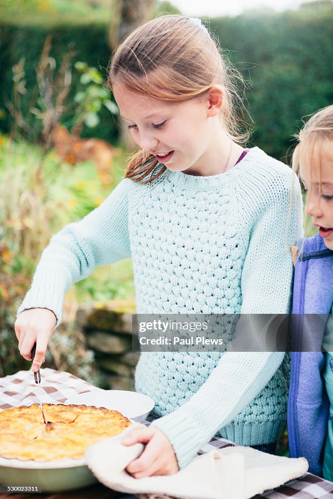 Girl cutting homemade pie