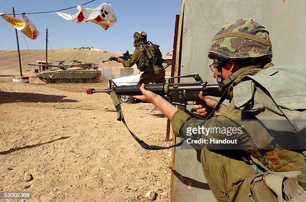 In this handout image provided by the Israeli Defense Forces , Israeli infantry and armor personnel hold a joint forces exercise May 31, 2005 at the...