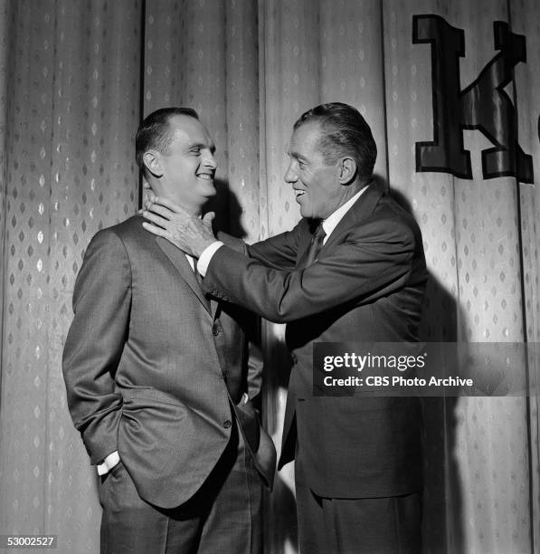 American television personality Ed Sullivan pretends to grab comedian Bob Newhart around the neck while on the set of 'The Ed Sullivan Show,' New...