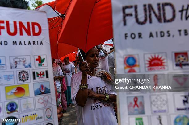 An Indian woman affected with HIV takes part in a rally in New Delhi on May 10 held to urge China, Germany and Japan to step up their contributions...