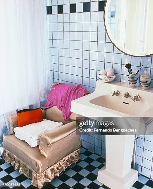 armchair by pedestal sink in tiled bathroom - light blue tiled floor stock pictures, royalty-free photos & images