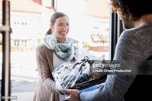 woman giving a gift to her friend at front door, munich, bavaria, germany - guest door ストックフォトと画像