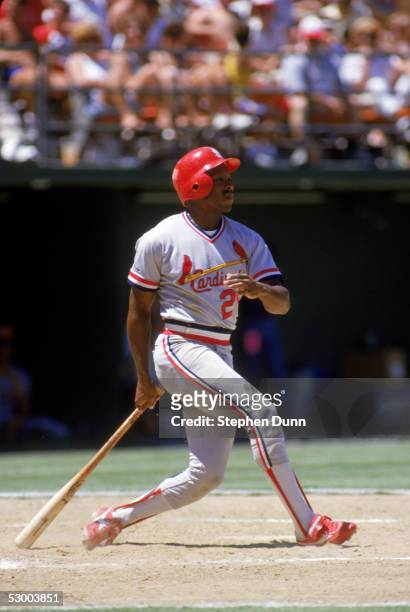 Vince Coleman of the St. Louis Cardinals watches the flight of the ball as he follows through on his swing during a game against the San Diego Padres...