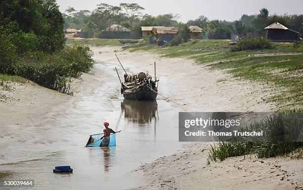 Mongla, Bangladesh A man fishes with a net in a river with low water level on April 12, 2016 in Mongla, Bangladesh.