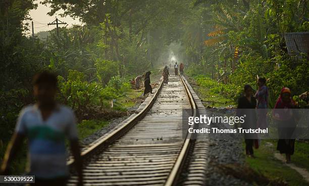 Mongla, Bangladesh People walk along the railway line in a rural area in the southwest of Bangladesh on April 12, 2016 in Mongla, Bangladesh.