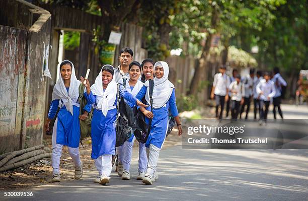Savar, Bangladesh Girls in school uniform walking along a road after school on April 13, 2016 in Savar, Bangladesh.