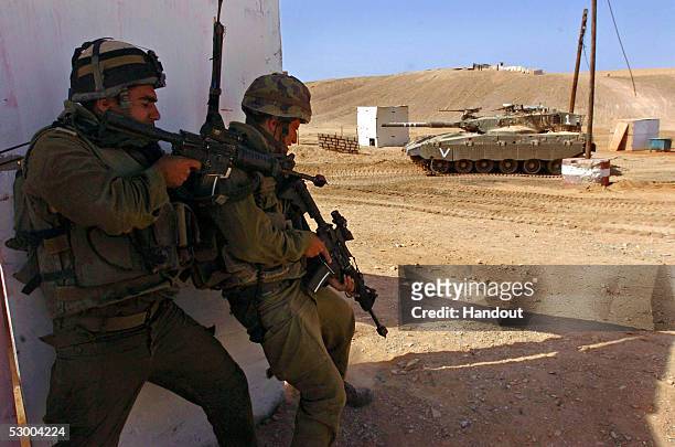 In this handout image provided by the Israeli Defense Forces , Israeli infantry and armor personnel hold a joint forces exercise May 31, 2005 at the...