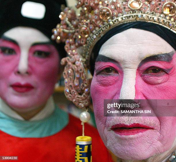 Cantonese opera performers display their make-up in Hong Kong, 21 May 2005. Before the 1950s Cantonese opera -- an art form that involves singing,...