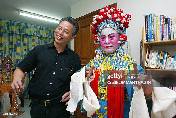 Chan Gum-to , Cantonese opera performer and instructor, demonstrates a performance pose to a student in Hong Kong, 21 May 2005. Chan has been given...