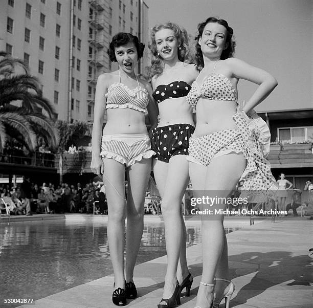 Sennett Bathing Beauties pose by a swimming pool in Los Angeles,CA.