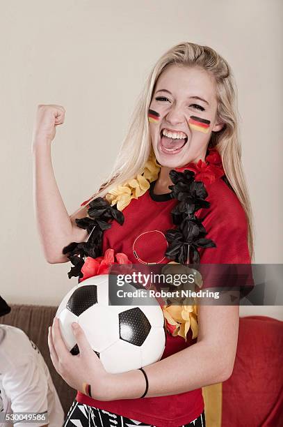 portrait of female teenage soccer fan - germany soccer stock-fotos und bilder