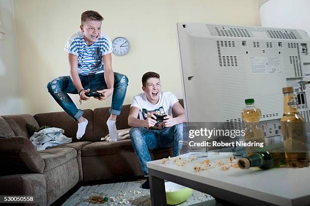 two teenage boys playing video game - faze rug stock pictures, royalty-free photos & images