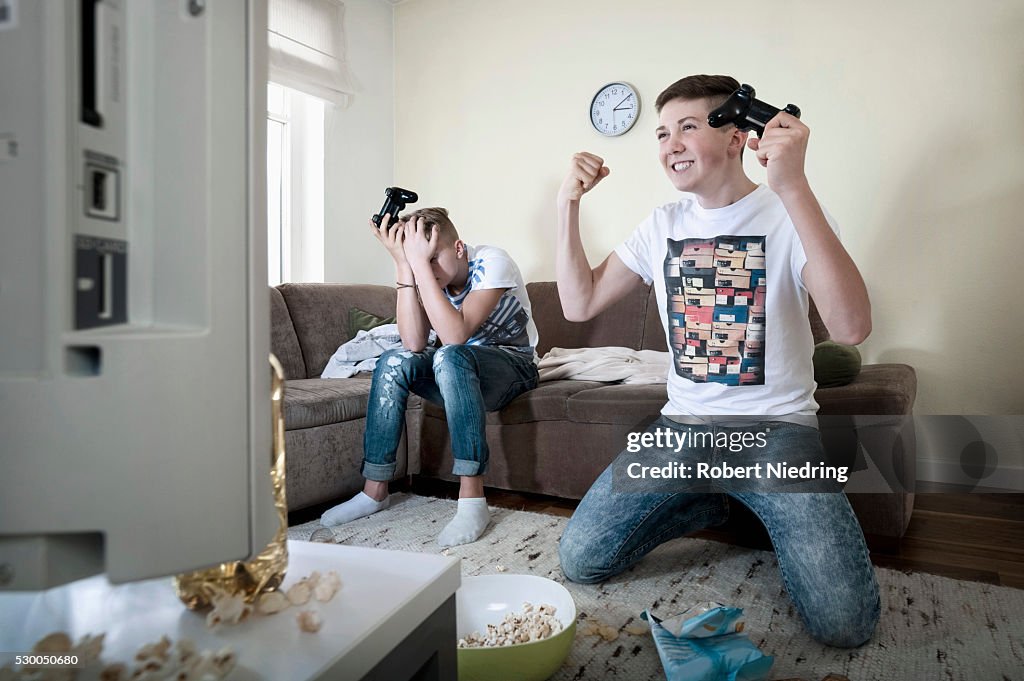 Two teenage boys playing video game
