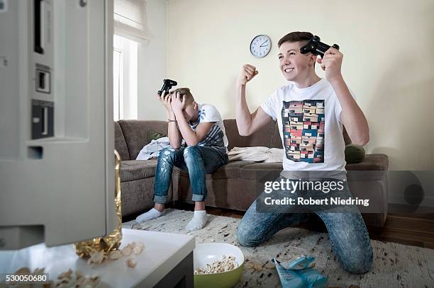 two teenage boys playing video game - faze rug stock pictures, royalty-free photos & images