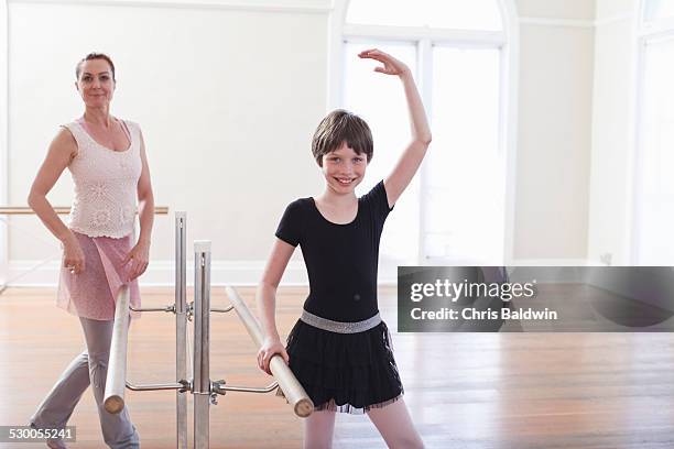 girl practicing ballet with teacher at the barre in ballet school - leotard and tights stock pictures, royalty-free photos & images