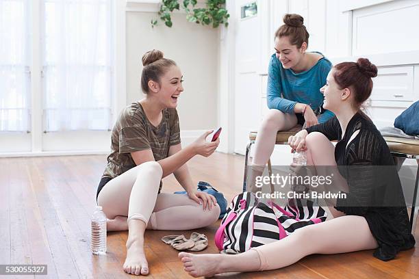 three teenage girls chatting and laughing in ballet school - girls tights stock pictures, royalty-free photos & images