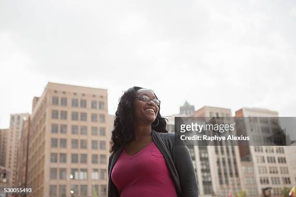 low angle portrait of smiling woman, detroit, michigan, usa - detroit michigan stock pictures, royalty-free photos & images