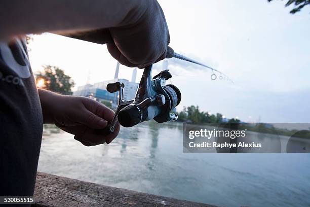 close up of man fishing on river raisin, monroe, michigan, usa - monroe michigan - fotografias e filmes do acervo