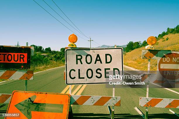 close up row of road closed signs on highway - detour stock pictures, royalty-free photos & images