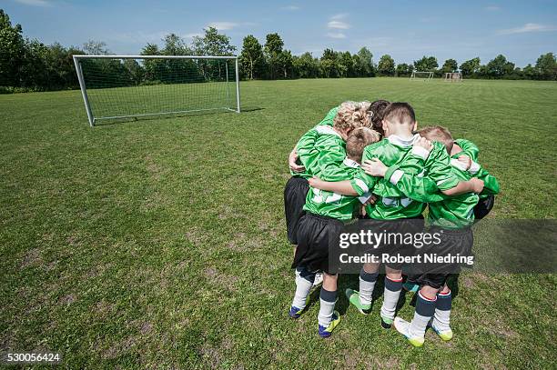 junior soccer team in huddle circle from above - team sport huddle stock pictures, royalty-free photos & images