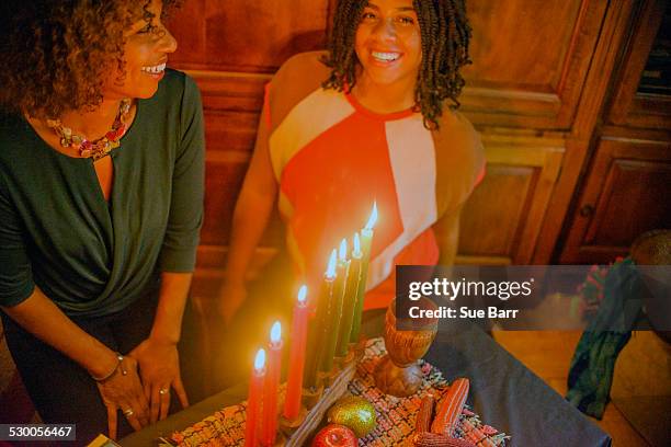 family celebrating kwanzaa - kwanzaa stock pictures, royalty-free photos & images