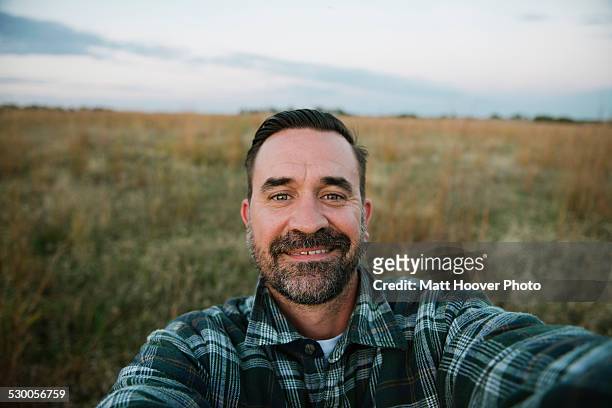 self portrait of smiling farmer in field, plattsburg, missouri, usa - farmer portrait stock-fotos und bilder