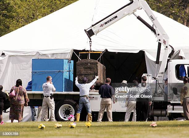 The burial vault containing the remains of Emmett Till is lowered onto a flatbed truck at Burr Oak Cemetery June 1, 2005 in Alsip, Illinois. The FBI...