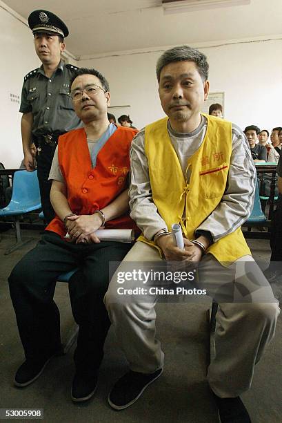 Zhang Xiaochuan and his younger brother Zhang Tiansheng stand trial on corruption charges on June 1, 2005 in Xian, Shaanxi Province, China. Zhang...