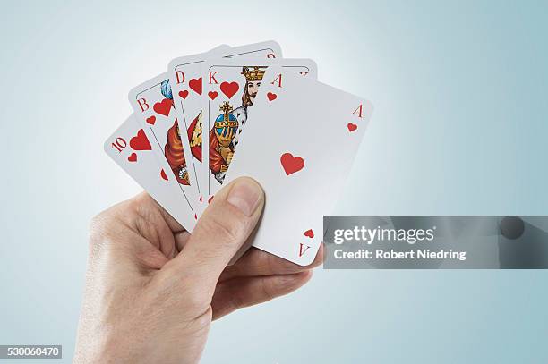 close-up of man's hand holding playing cards, bavaria, germany - face card stock-fotos und bilder