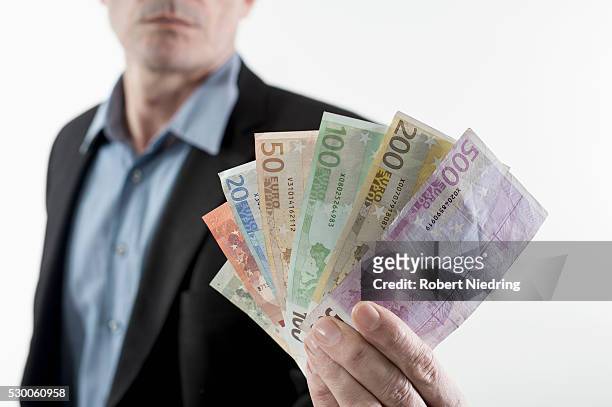 businessman showing euro banknotes, bavaria, germany - two hundred euro banknote stock pictures, royalty-free photos & images