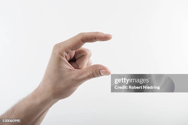 close-up of man's hand indicating size with fingers, bavaria, germany - zeigefinger stock-fotos und bilder