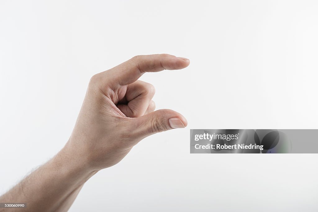 Close-up of man's hand indicating size with fingers, Bavaria, Germany