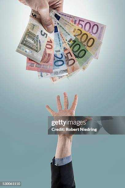 hand reaching out for money, bavaria, germany - two hundred euro banknote stock pictures, royalty-free photos & images