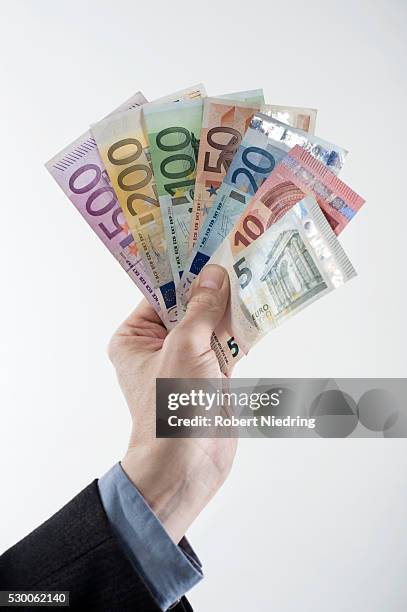 businessman's hand showing euro banknotes, bavaria, germany - two hundred euro banknote stock pictures, royalty-free photos & images