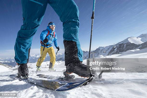 ski mountaineers climbing on snowy mountain in snow storm, zell am see, austria - tirol deelstaat stockfoto's en -beelden