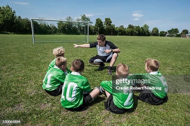 football coach talking to young boys team - athlete bulges stock pictures, royalty-free photos & images