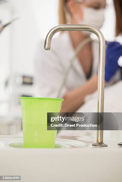 dental cuspidor with a disposable cup in dental clinic, munich, bavaria, germany - bicchiere di carta foto e immagini stock