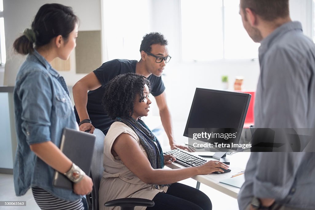 USA, New Jersey, Jersey City, Women and men working in office