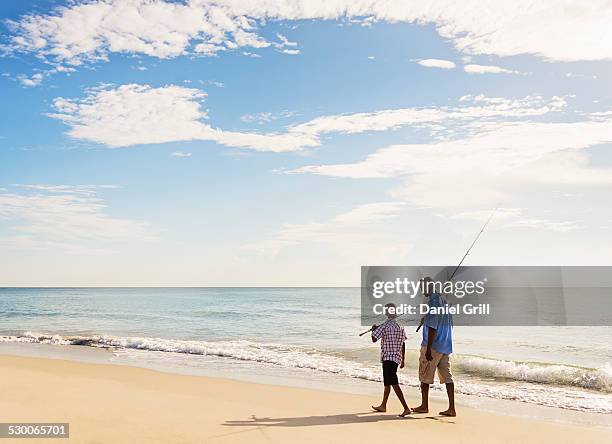 usa, florida, jupiter, father and son (10-11) fishing - beach florida family stockfoto's en -beelden