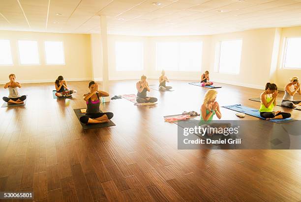 usa, florida, west palm beach, women exercising yoga - yoga studio stock pictures, royalty-free photos & images